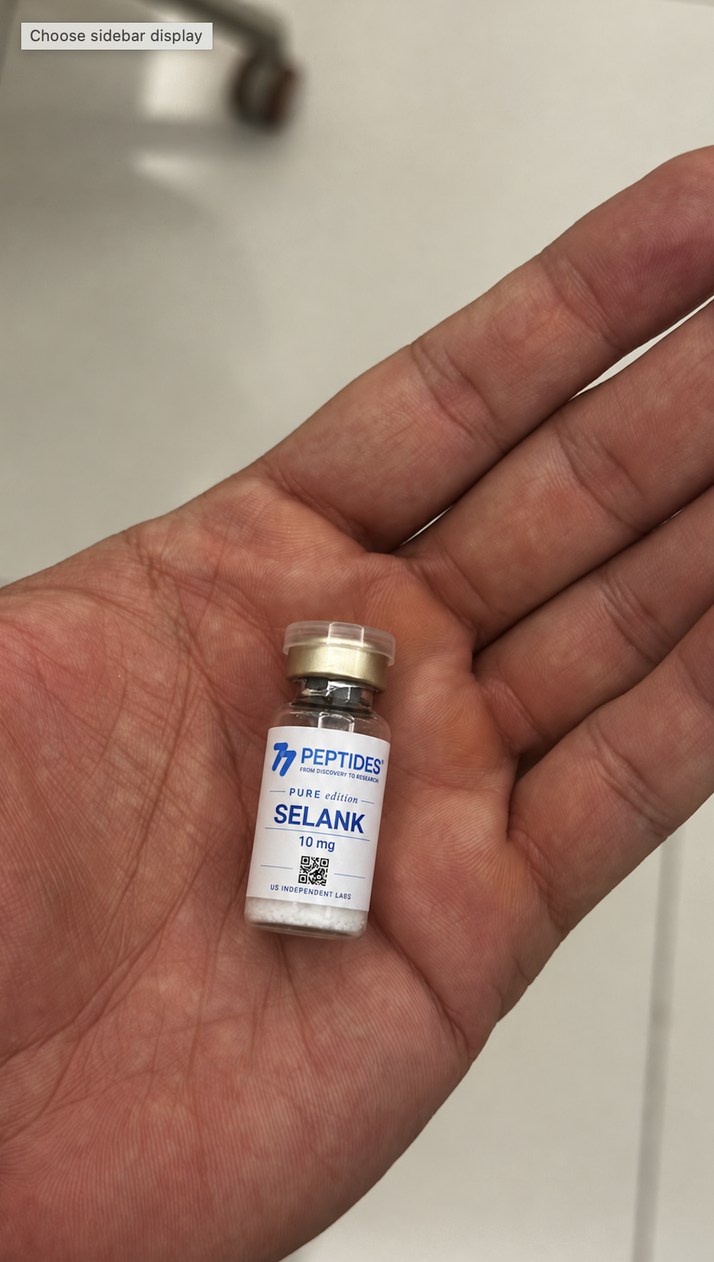 Selank 10 mg vial held in a palm
